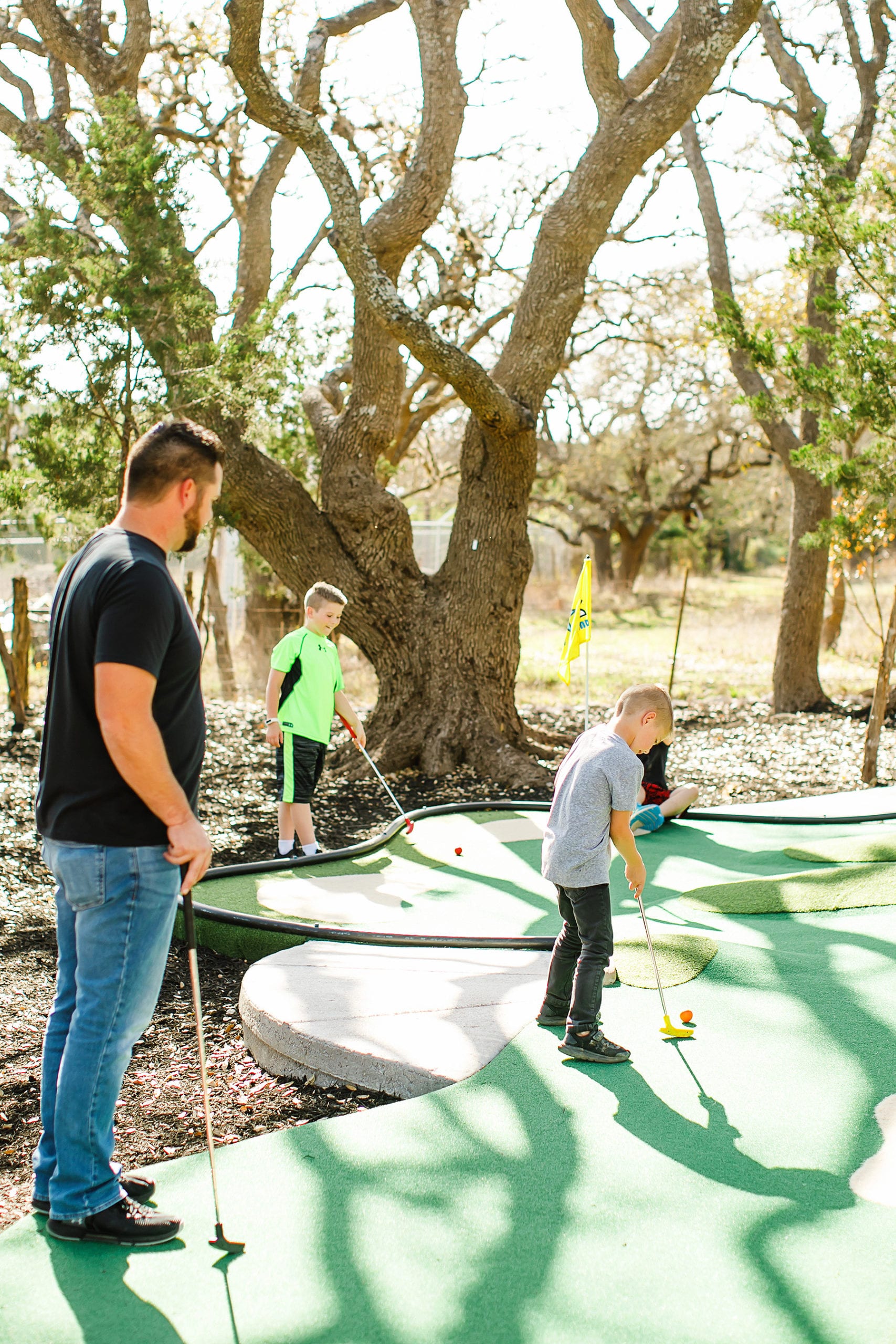 Family plays at Dreamland outdoor mini golf in Dripping Springs