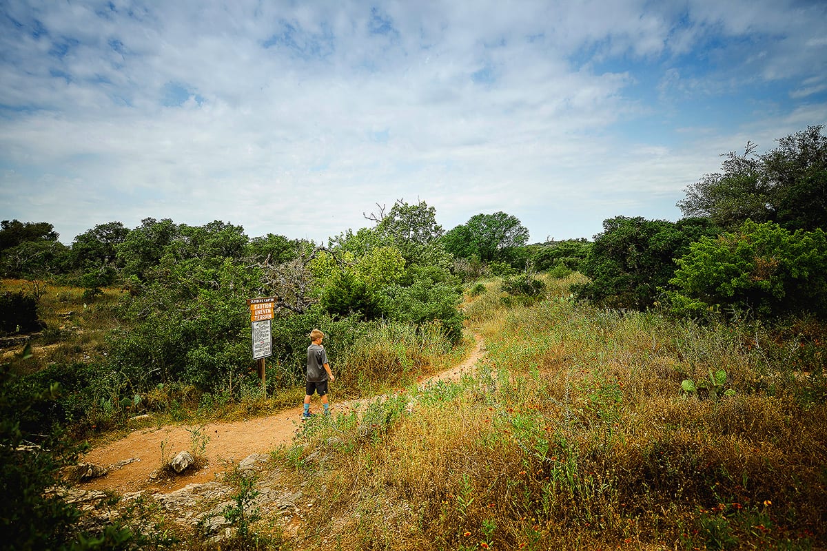 Kid hiking at Milton Reimer's Ranch in Dripping Springs