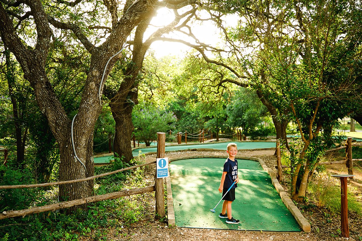 Roadrunners Dripping Springs, Texas boy playing mini golf