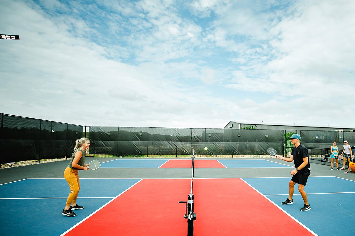 Candace and Jay Sant playing pickleball at Dreamland in Dripping Springs, Texas
