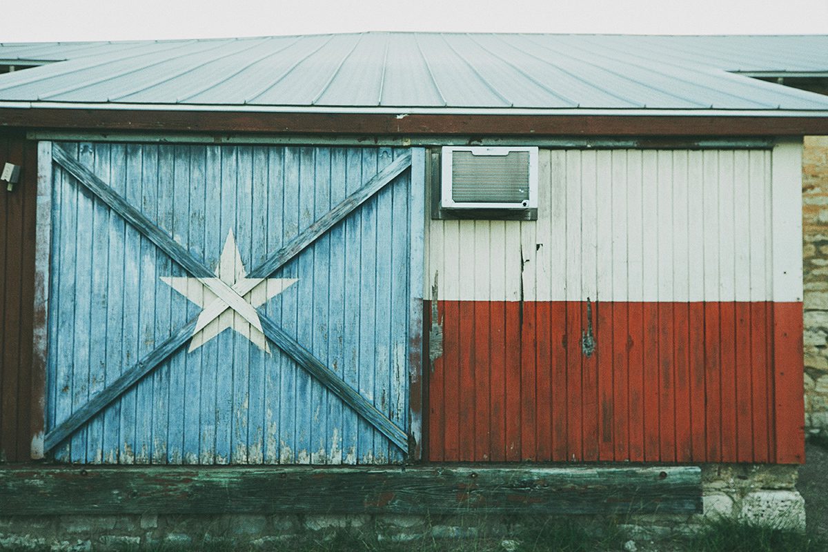 Historic Dripping Springs Texas flag wall on Mercer Street
