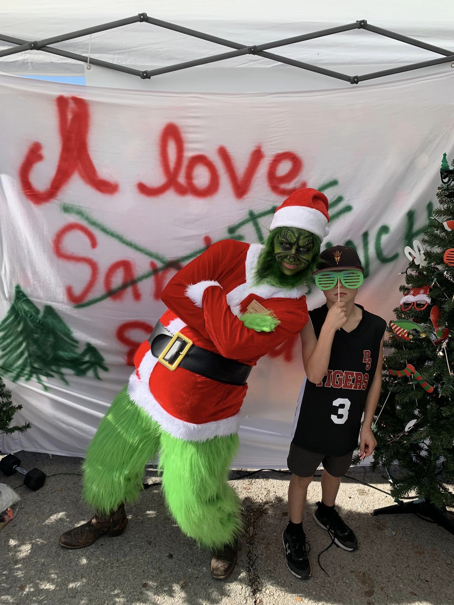 Lauren Clark as the Grinch for Christmas on Mercer with Magnolia Realty Booth 2022