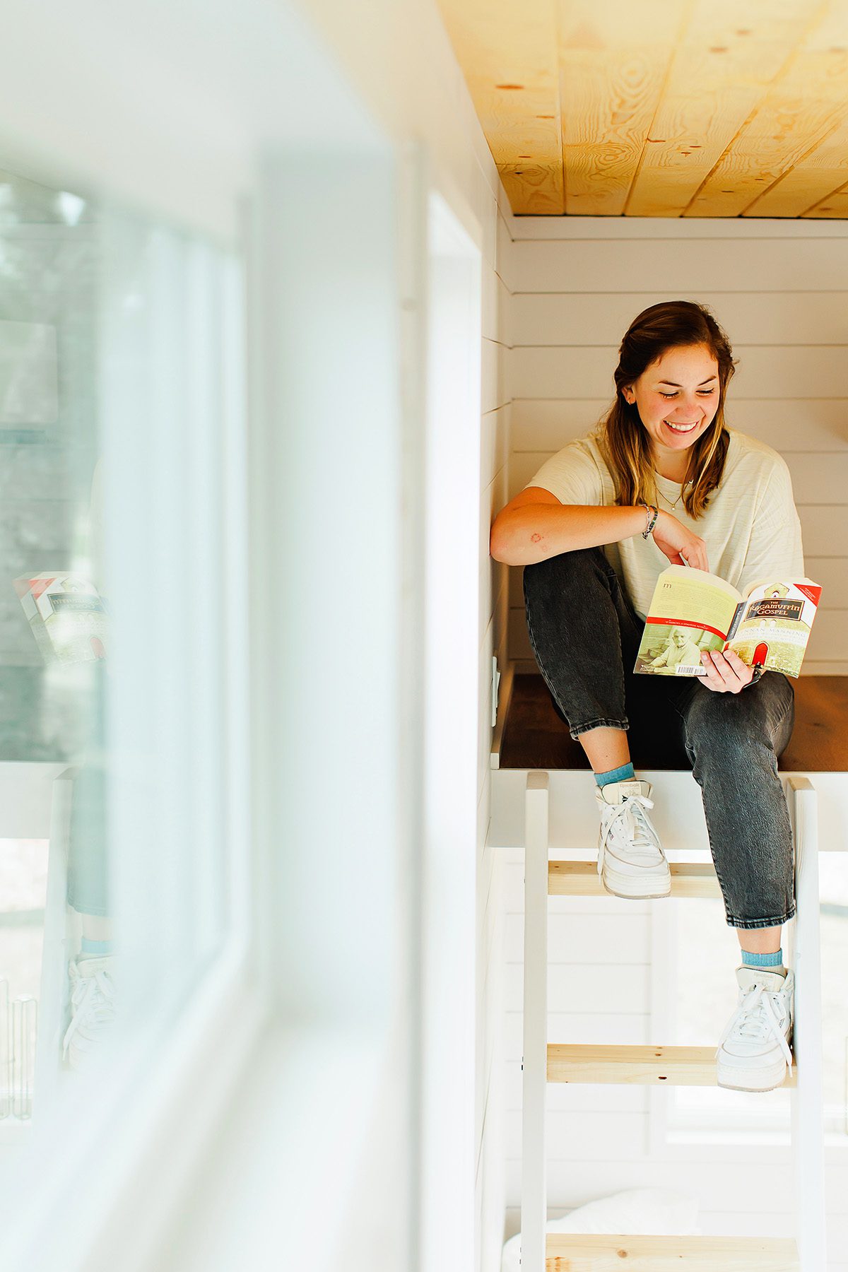 Emily Weyand, Dripping Springs High School math teacher reading a book in her tiny house