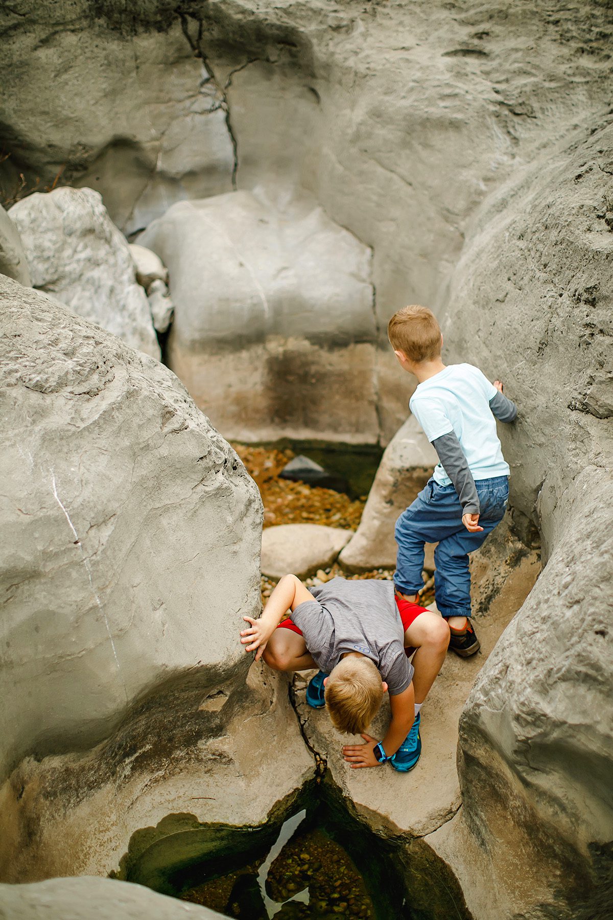 Kids exploring the Pedernals Falls limestone caverns