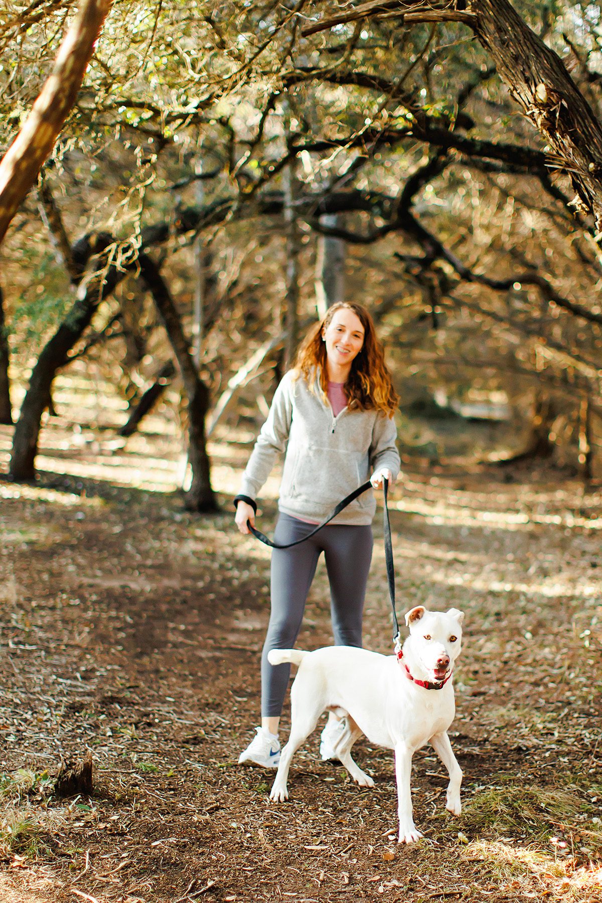 Bridget Wolfe walking a dog at PAWS animal shelter in Dripping Springs, Texas. Owner of Wild Wolfe Pack Treats. 