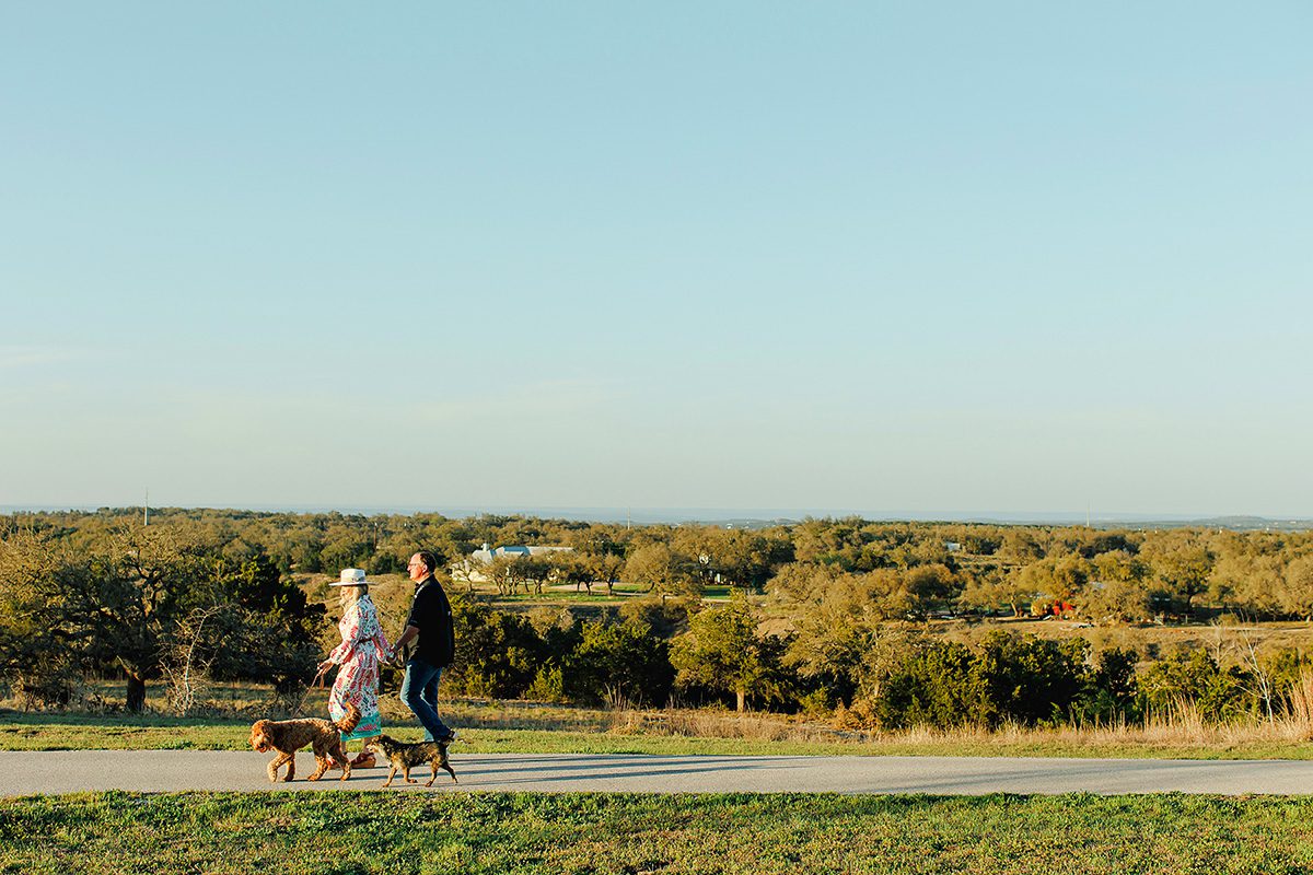 Julie Crawford and Tom Crawford, owners of Vintage Soul Tx in Dripping Springs, walking their dogs by their home