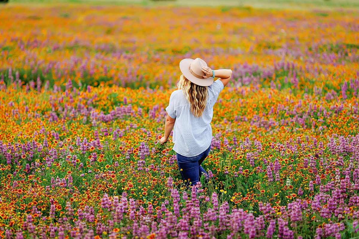 Lauren Clark in a field of wildflowers